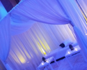 Sheer curtains for draping seating area featuring up-lights and candles to lighten up the mood. 