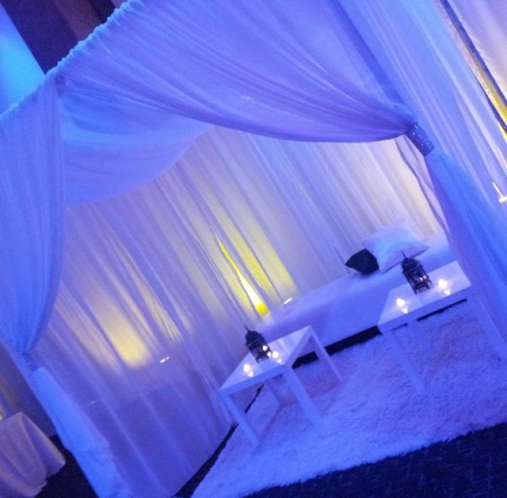 Sheer curtains for draping seating area featuring up-lights and candles to lighten up the mood. 
