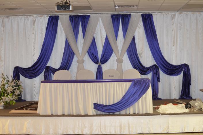 Purple and white drapery for the bride and groom table.