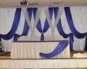 Purple and white drapery for the bride and groom table.