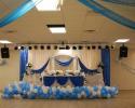 This beautiful bridal table features gorgeous white and blue drapery behind it, as well as on the table. Also, the ceiling features gorgeous draping too.