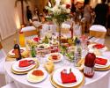 This reception table is all set and ready to go with the gold and white place settings, orange napkins and beautiful centerpiece.